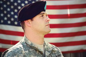 a man in military uniform in front of a flag